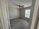 Bright bedroom with wood-look flooring, ceiling fan, and a window at 1103 Jade East Ln # 1103, Kissimmee, FL 34744