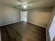 Cozy bedroom with wood-look flooring and a ceiling fan at 1103 Jade East Ln # 1103, Kissimmee, FL 34744