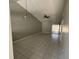 Bright living room featuring vaulted ceilings, tile floors, and slider to the outdoors at 1103 Jade East Ln # 1103, Kissimmee, FL 34744