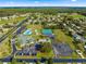 Community clubhouse with swimming pool, tennis courts, and parking area at 11643 Sw 137Th Loop, Dunnellon, FL 34432