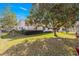 Spacious backyard with lush lawn and mature trees creating a shady retreat at 11643 Sw 137Th Loop, Dunnellon, FL 34432
