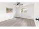 Well-lit bedroom with two windows and plank flooring, offering a clean and comfortable space at 11643 Sw 137Th Loop, Dunnellon, FL 34432