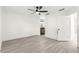 Bright, minimalist bedroom with ceiling fan and an en-suite bathroom, featuring stylish plank flooring at 11643 Sw 137Th Loop, Dunnellon, FL 34432