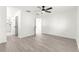 Bright bedroom featuring hardwood floors, a ceiling fan, and an ensuite bathroom with modern fixtures at 11643 Sw 137Th Loop, Dunnellon, FL 34432