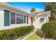 Charming home with a well-manicured lawn, green shutters, and a pop of color from the orange front door at 11643 Sw 137Th Loop, Dunnellon, FL 34432