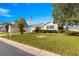 Well-maintained single-story home with lush lawn, landscaping, and attached two-car garage at 11643 Sw 137Th Loop, Dunnellon, FL 34432