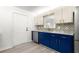 Updated kitchen featuring blue cabinets, white countertops, tile backsplash, and stainless steel appliances at 11643 Sw 137Th Loop, Dunnellon, FL 34432