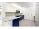 Beautiful renovated kitchen boasting white cabinets, blue island, stainless steel appliances and mosaic backsplash at 11643 Sw 137Th Loop, Dunnellon, FL 34432