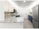 Renovated kitchen boasting granite countertops, stainless steel appliances, and mosaic backsplash at 11643 Sw 137Th Loop, Dunnellon, FL 34432