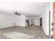Well-lit living room boasts wood-look floors and flows into the kitchen at 11643 Sw 137Th Loop, Dunnellon, FL 34432