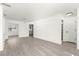 Open-concept living area showcasing wood-look flooring and neutral color scheme at 11643 Sw 137Th Loop, Dunnellon, FL 34432
