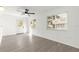 Bright living room with wood-look floors, ceiling fan, and natural light from multiple windows at 11643 Sw 137Th Loop, Dunnellon, FL 34432