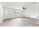 Bright living room with wood-look floors, ceiling fan, and a front door with decorative window at 11643 Sw 137Th Loop, Dunnellon, FL 34432