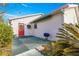 Back patio with a red entry door, a grill, and a retractable awning at 11643 Sw 137Th Loop, Dunnellon, FL 34432