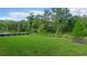 Expansive backyard featuring lush green grass and bordered by a line of vibrant trees and bushes at 1251 Cresswind Blvd, Deland, FL 32724