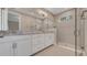 Well-lit bathroom featuring a double vanity, and a spacious glass-enclosed shower offering a spa-like experience at 1251 Cresswind Blvd, Deland, FL 32724