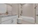 Bright bathroom featuring a shower over a bathtub and a vanity with a granite countertop at 1251 Cresswind Blvd, Deland, FL 32724