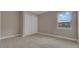 Neutral bedroom with carpeting, double door closet, and bright window at 1251 Cresswind Blvd, Deland, FL 32724