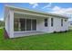 Exterior view of a house featuring a brick paver patio, sliding glass doors, and manicured lawn at 1251 Cresswind Blvd, Deland, FL 32724