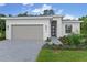Beautiful one-story home with a gray garage door, gray brick paver driveway, and inviting landscaped front yard at 1251 Cresswind Blvd, Deland, FL 32724