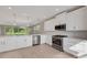 Bright kitchen with stainless steel appliances, white cabinets, a large island, and stylish lighting creating a welcoming space at 1251 Cresswind Blvd, Deland, FL 32724