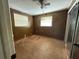 A bedroom with wood paneled walls, natural light, and a ceiling fan at 1348 Cr 605, Bushnell, FL 33513