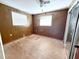 Bedroom featuring paneled walls and window and access to the exterior at 1348 Cr 605, Bushnell, FL 33513