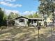 Charming single-story home with a carport and well-kept front lawn showcasing its inviting curb appeal at 1348 Cr 605, Bushnell, FL 33513