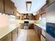 A full kitchen with wood cabinets, stainless steel appliances, and lots of natural light at 1348 Cr 605, Bushnell, FL 33513