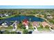 A stunning aerial view showcasing a home near a tranquil lake with mature trees at 136 Majestic Forest Run, Sanford, FL 32771