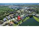 An aerial shot of a residential community with a lake. The property features well-maintained landscaping at 136 Majestic Forest Run, Sanford, FL 32771