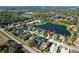 Beautiful aerial view of community showcasing a lake, mature trees, and green landscaping at 136 Majestic Forest Run, Sanford, FL 32771