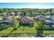 A beautiful backyard with green grass, a charming patio, and bordered by a scenic pond at 136 Majestic Forest Run, Sanford, FL 32771