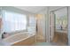 Bathroom featuring a standalone tub and glass enclosed shower at 136 Majestic Forest Run, Sanford, FL 32771