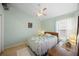 Cozy bedroom featuring a ceiling fan, window with natural light, and soft carpet at 136 Majestic Forest Run, Sanford, FL 32771