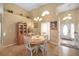 Inviting dining space with a chandelier, high ceilings, and a sunny window, complemented by a cabinet at 136 Majestic Forest Run, Sanford, FL 32771