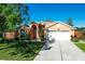 Charming single-Gathering home with stucco exterior, arched entry, manicured lawn, and a two-car garage at 136 Majestic Forest Run, Sanford, FL 32771