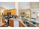 Open kitchen showcases wood cabinets, granite countertops, and modern appliances at 136 Majestic Forest Run, Sanford, FL 32771