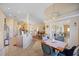 Open-concept kitchen featuring granite countertops and stainless steel appliances flowing into living areas at 136 Majestic Forest Run, Sanford, FL 32771