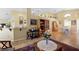 Open-concept living area with tile flooring and vaulted ceilings, enhanced by decorative shelving and a view into the dining area at 136 Majestic Forest Run, Sanford, FL 32771