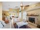 Spacious living room with vaulted ceilings, a fireplace, and tile floors, leading into the kitchen and dining area at 136 Majestic Forest Run, Sanford, FL 32771