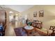 Bright living room boasts high ceilings, tile floors, and an open floor plan into the dining and front entry area at 136 Majestic Forest Run, Sanford, FL 32771