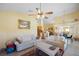 Open living room with vaulted ceilings, a ceiling fan, tile floors, and clear views to the kitchen and dining area at 136 Majestic Forest Run, Sanford, FL 32771