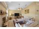 Bright living room featuring a fireplace, fan, and a large TV, perfect for relaxation and entertainment at 136 Majestic Forest Run, Sanford, FL 32771