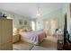 Main bedroom featuring a ceiling fan, access to a balcony, and an ensuite bath at 136 Majestic Forest Run, Sanford, FL 32771