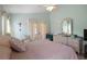 Bright main bedroom with ample natural light, ceiling fan, and ensuite bathroom access at 136 Majestic Forest Run, Sanford, FL 32771