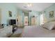 Large main bedroom showcasing neutral carpeting, pastel walls, and an ensuite bathroom at 136 Majestic Forest Run, Sanford, FL 32771