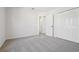 Bedroom features neutral carpet, closet, and a view to other parts of the home at 1368 Falconwood Ct, Apopka, FL 32712