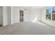 Bright bedroom featuring plush carpeting, neutral walls, with a large window and ensuite bathroom at 1368 Falconwood Ct, Apopka, FL 32712