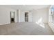 Bright bedroom featuring plush carpeting, neutral walls, with an ensuite bathroom and stairwell views at 1368 Falconwood Ct, Apopka, FL 32712